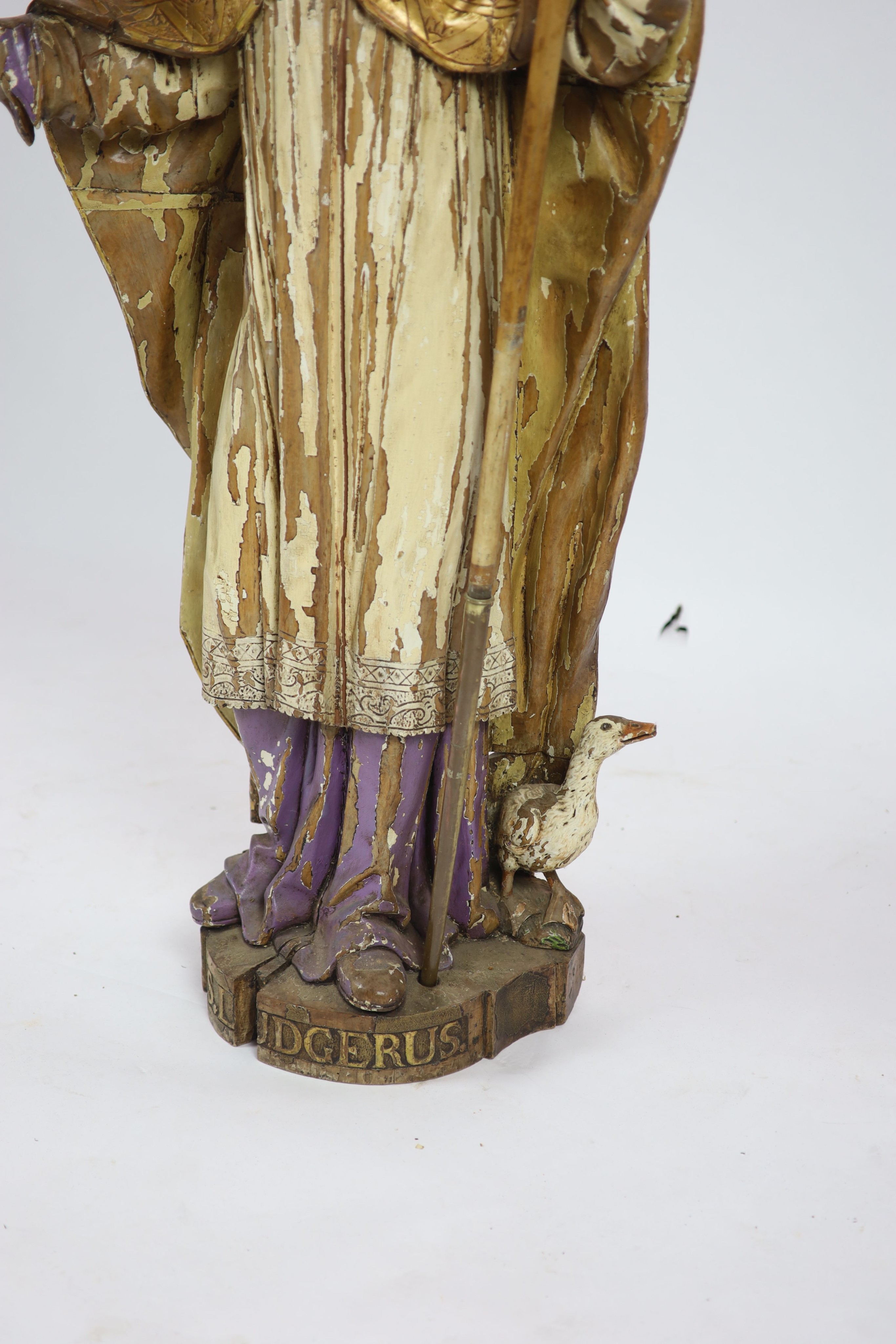 A 19th century German painted carved wood figure of St Ludgerus (b.742) H 157cm.